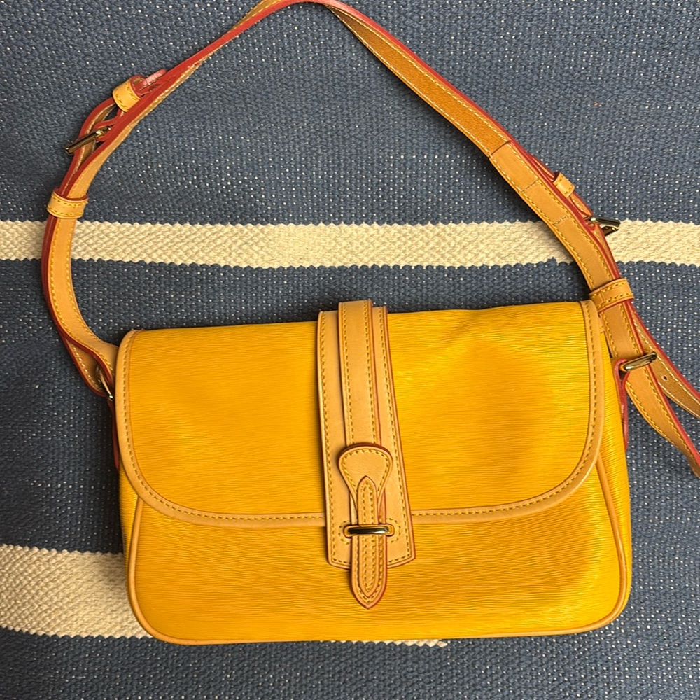 Vintage Dooney and Bourke yellow shoulder bag with red inside and stitching.
